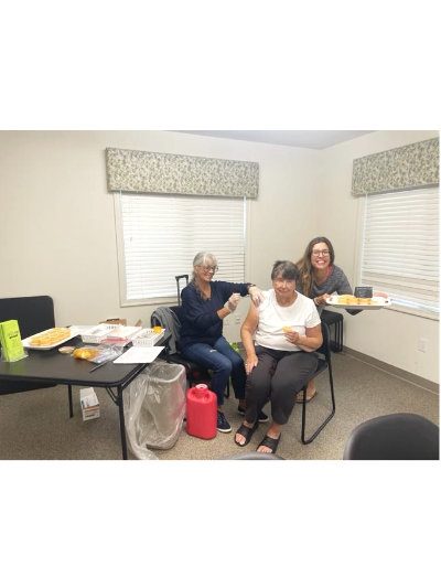Flu shot with treats. Susie Sullivan (l.) with and Lisa Daisey DiFebo provided healthy treats.
